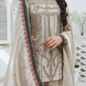 Champagne-gold bridal dress in silk tissue with fully hand-embroidered shirt and garara, handmade sleeve hangings, and zari tissue dupatta with velvet embroidered borders.