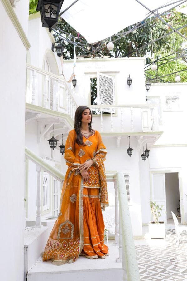 "Traditional orange bridal mehndi dress with embroidered kameez and gharara