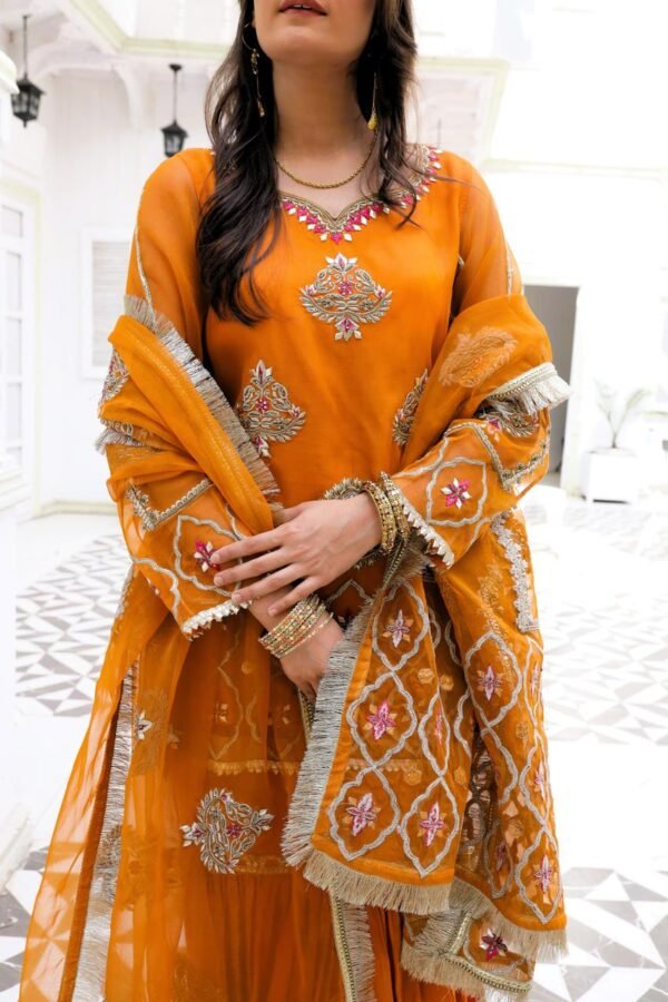 Traditional orange bridal mehndi dress with embroidered kameez and gharara